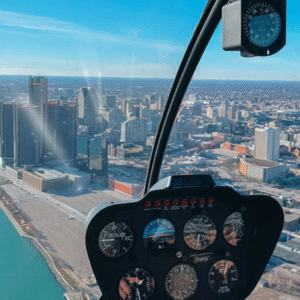 Aerial view of downtown Detroit at dusk from inside a private helicopter tour, with a couple silhouetted against the skyline.